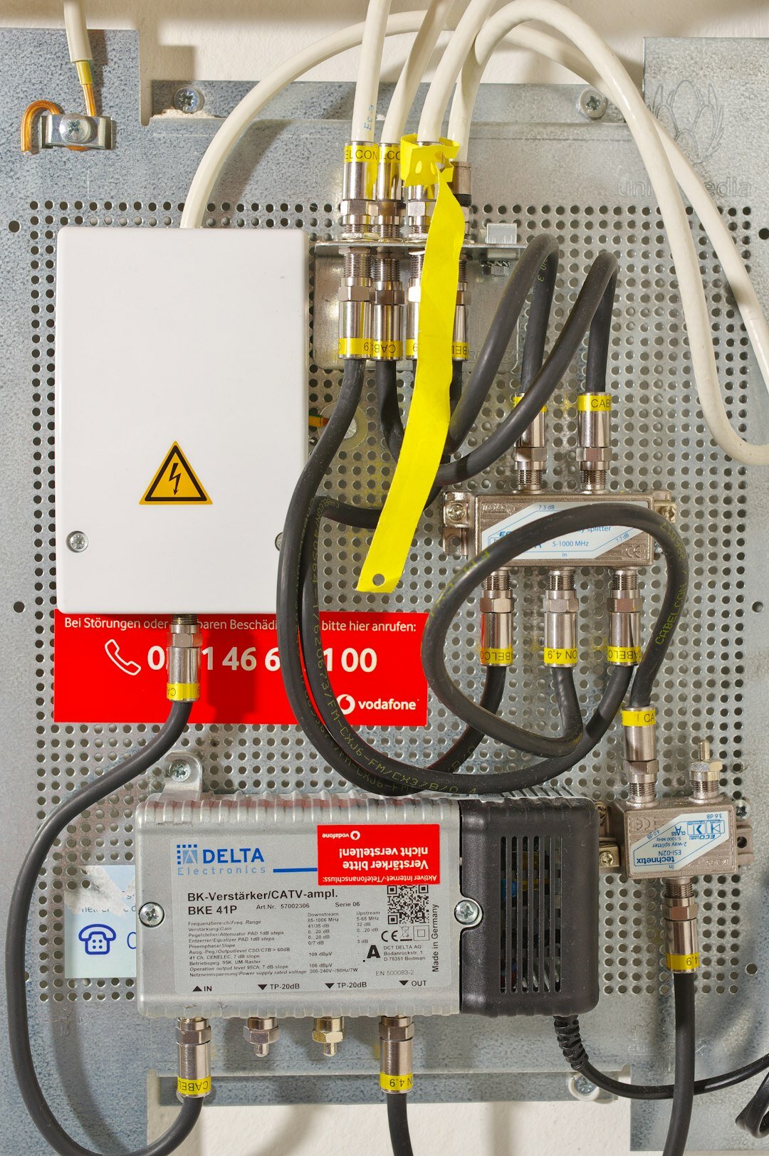 Rack of broadcast signal management equipment with cables and routers