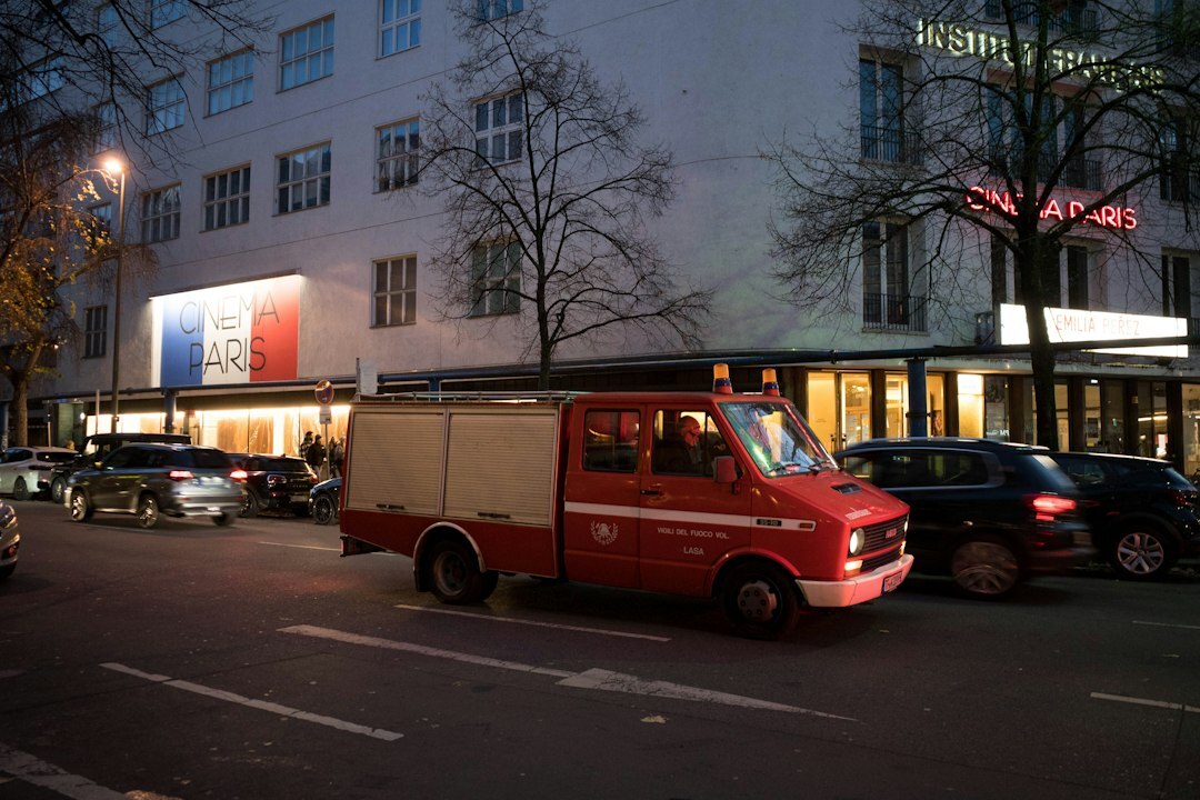 Outside broadcast van with satellite dish at a live event in the evening